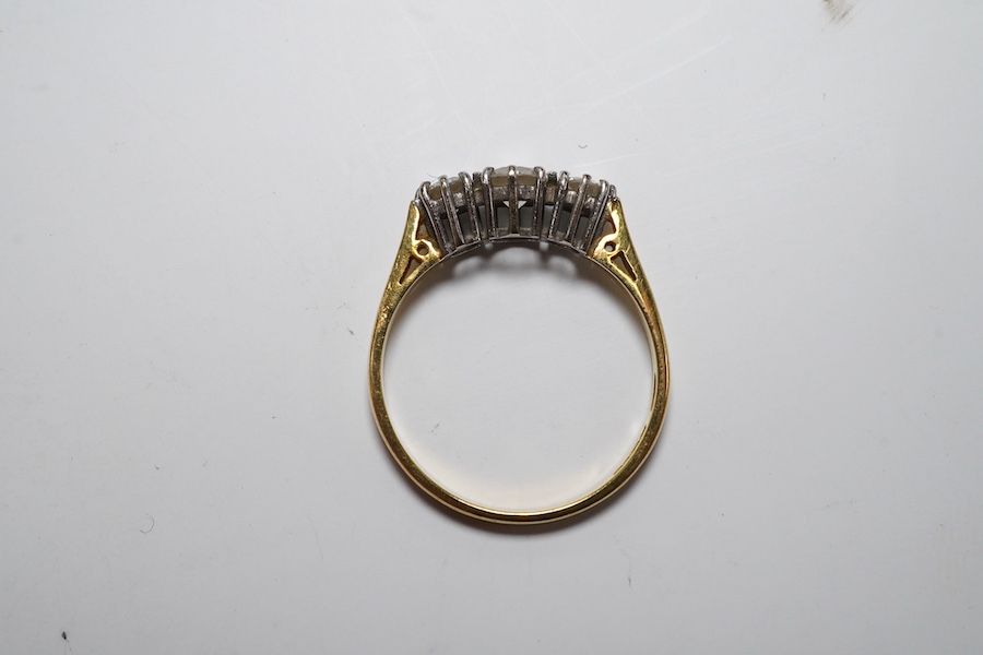 A modern 18ct gold and three stone diamond set ring, size M, gross weight 2.1 grams. Condition - fair to good